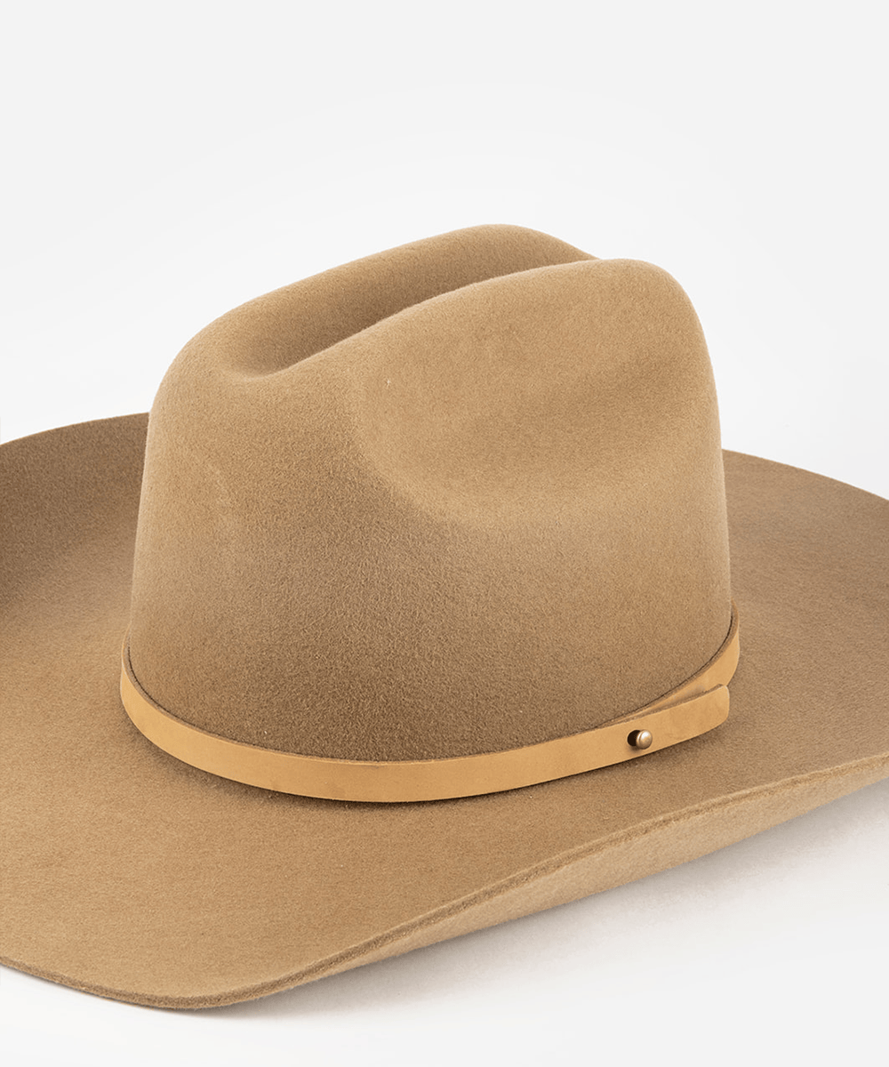 Brown cowboy hat with a nude leather band on a white background #color_nude