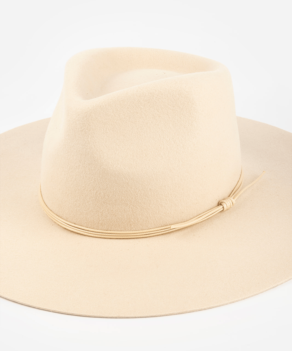 Pink cowboy hat with a cream triple strand band on a white background #color_cream