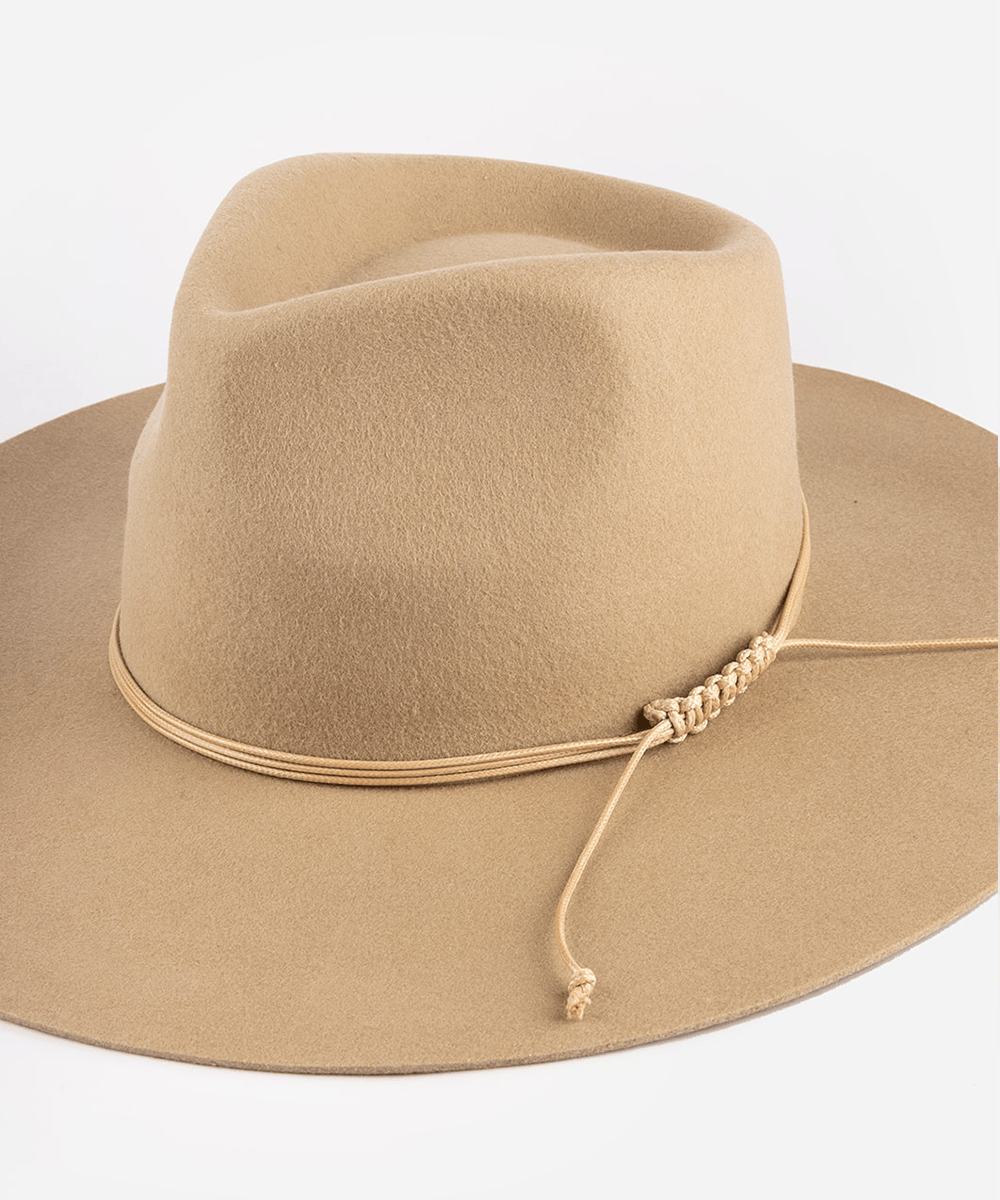 Beige cowboy hat with a string triple wrap band on a white background #color_tan