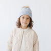Gigi Pip beanies for kids - Milo Beanie - soft knit ribbers kid's beanie featuring a fold up brim with a rose gold Gigi Pip logo pin on the side of the fold and a pom pom on the center of the crown [periwinkle]