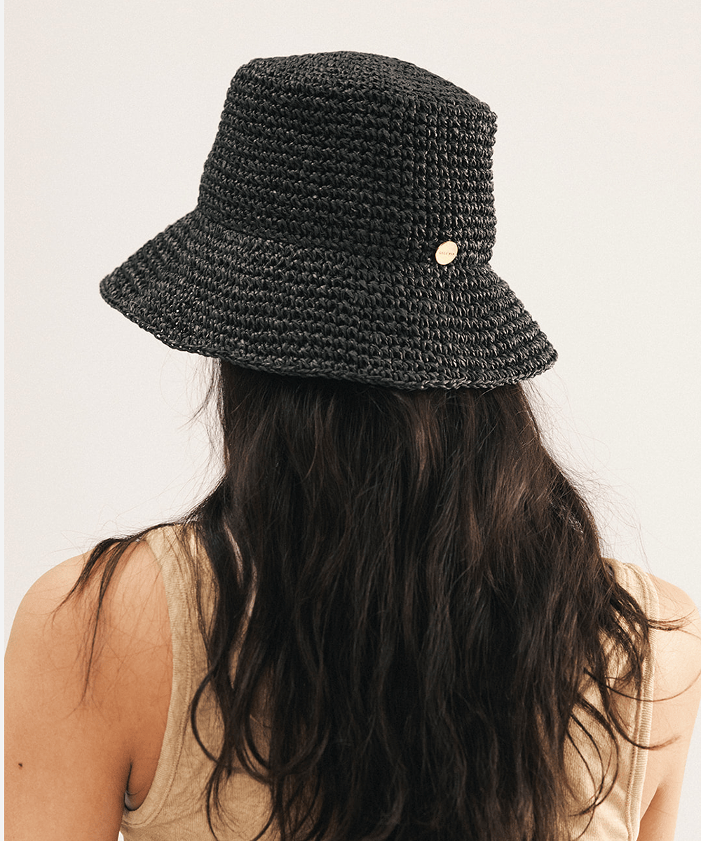 Woman wearing a black woven bucket hat on a white background
#color_black