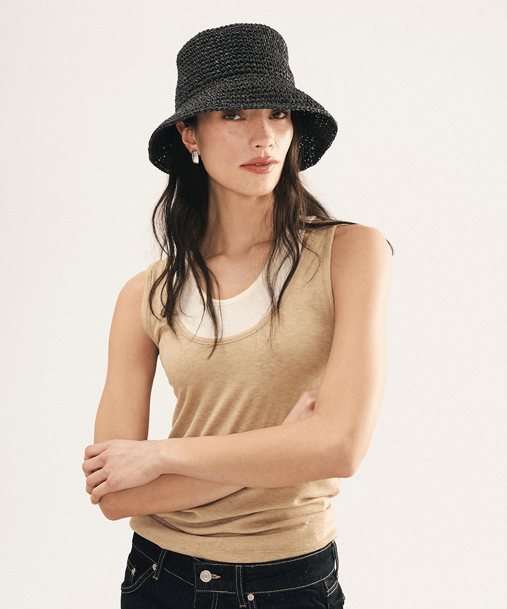Woman wearing a black woven bucket hat on a white background
#color_black