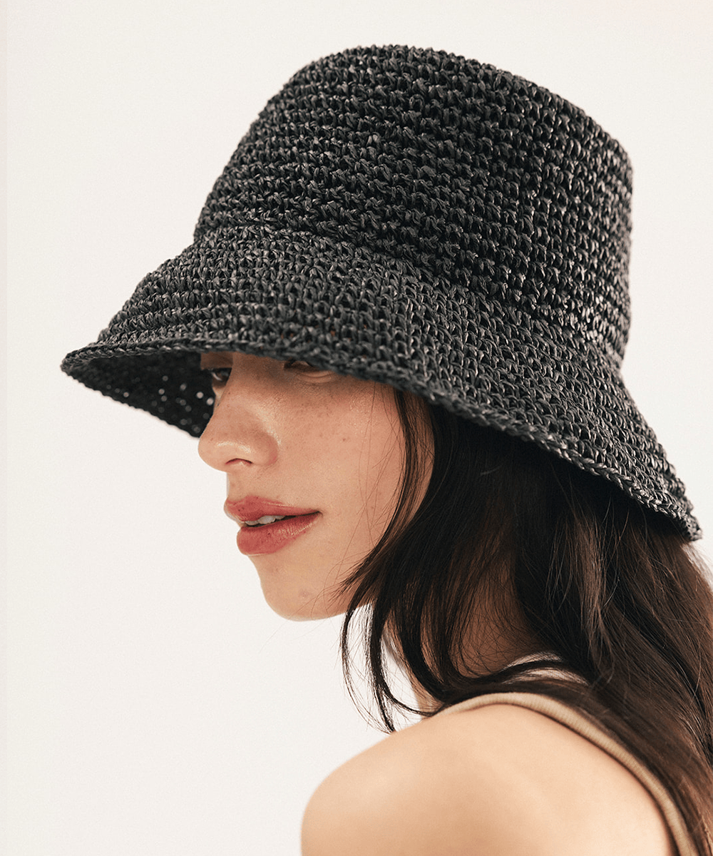 Woman wearing a black woven bucket hat on a white background
#color_black