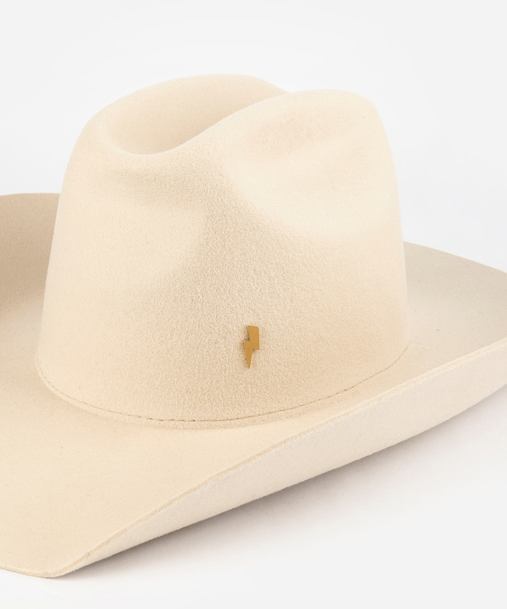 Pink cowboy hat with a gold lightning bolt-shaped hat pin on a white background #color_gold