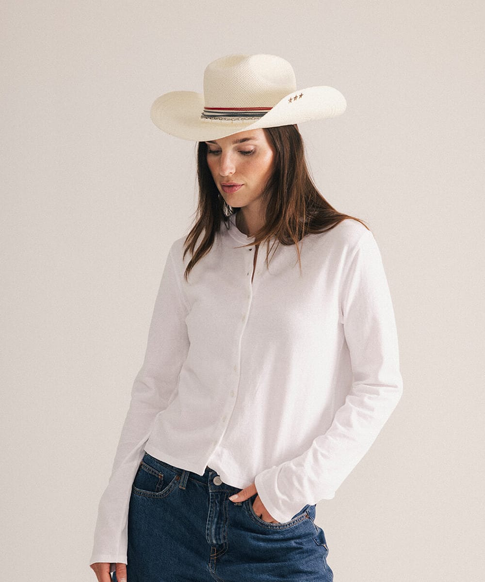 Woman wearing a cowboy hat with decorative bands in a plain background #color_natural white