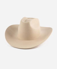 A cream cowboy hat with a stiff, traditional wide western brim and a brick top style crown. #color_cream