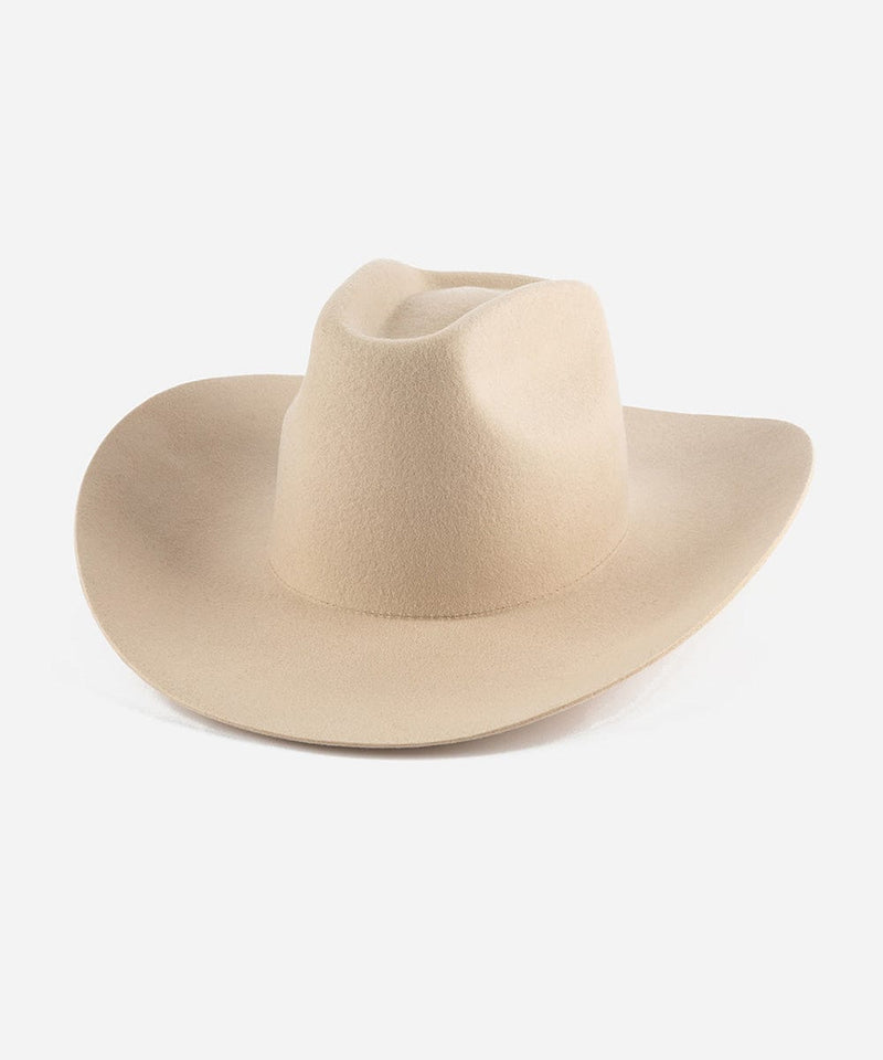 A cream cowboy hat with a stiff, traditional wide western brim and a brick top style crown. #color_cream