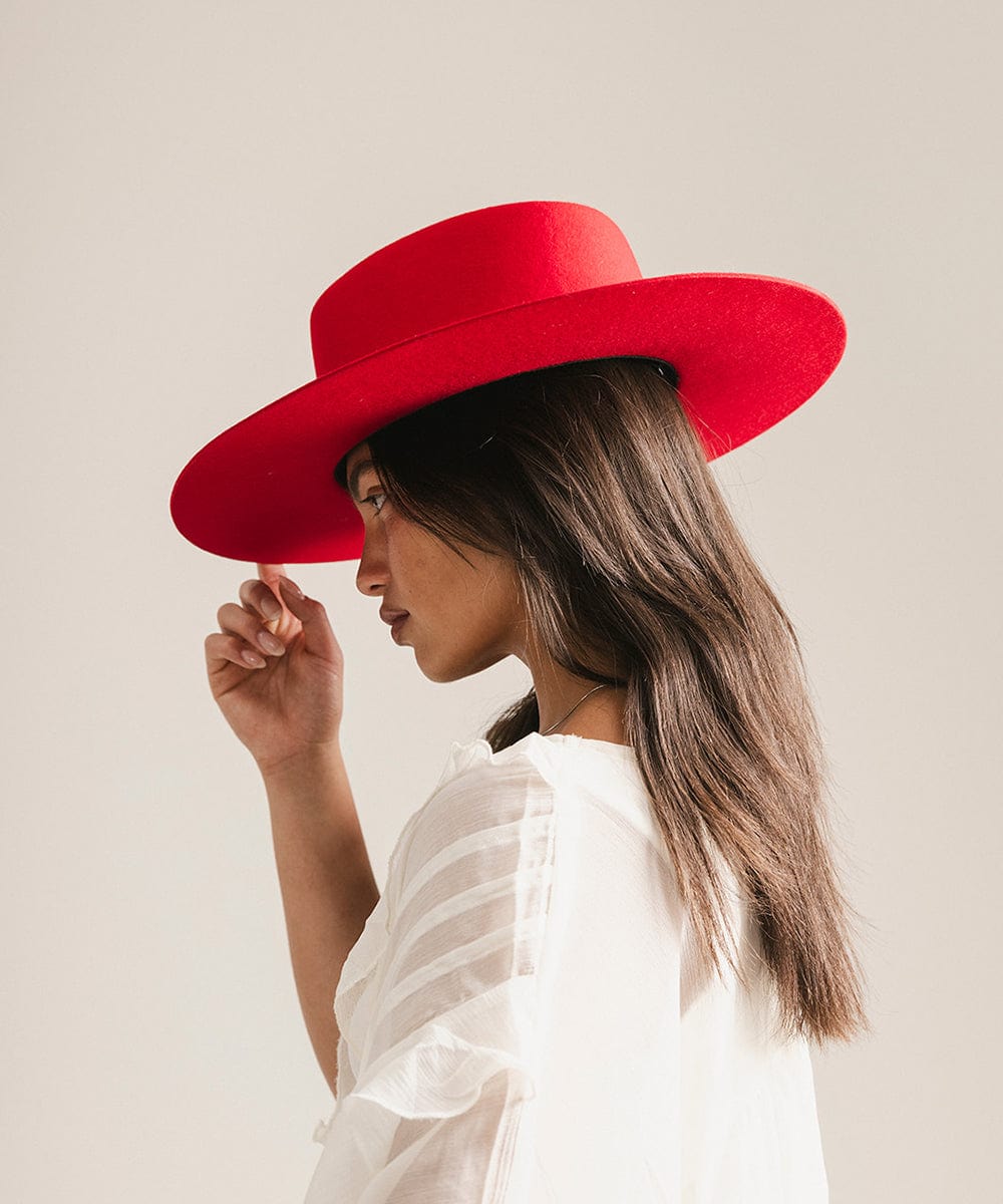 Woman wearing a red hat against a plain background #color_cherry red