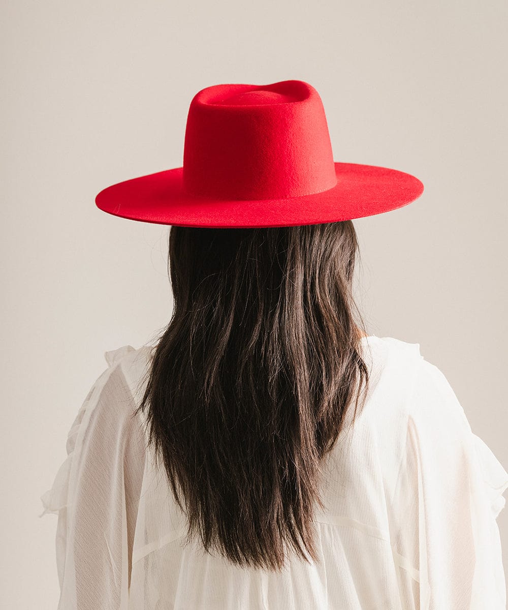 Person wearing a red hat and white shirt against a plain background #color_cherry red