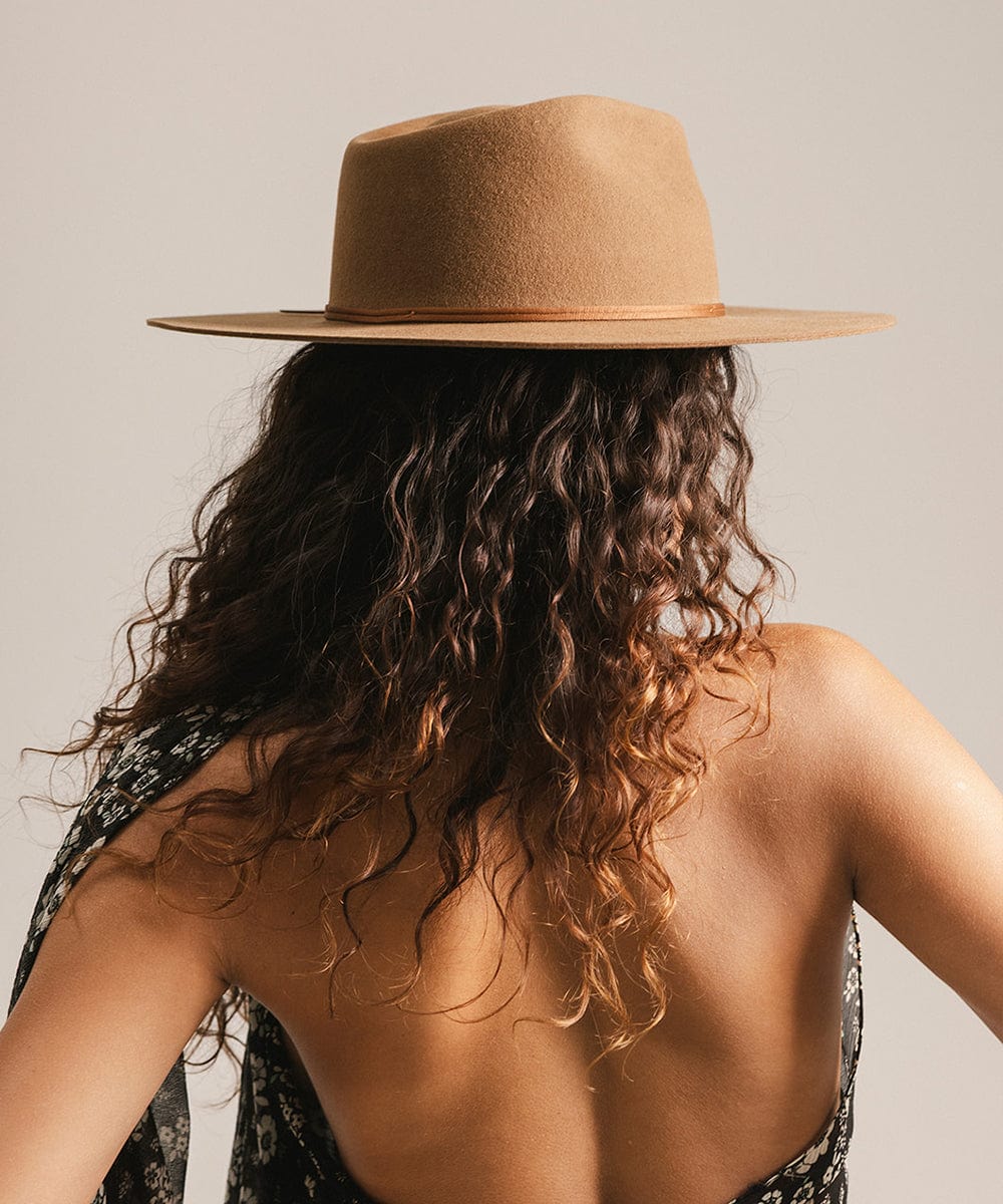 Person wearing a brown hat with a neutral background #color_caramel