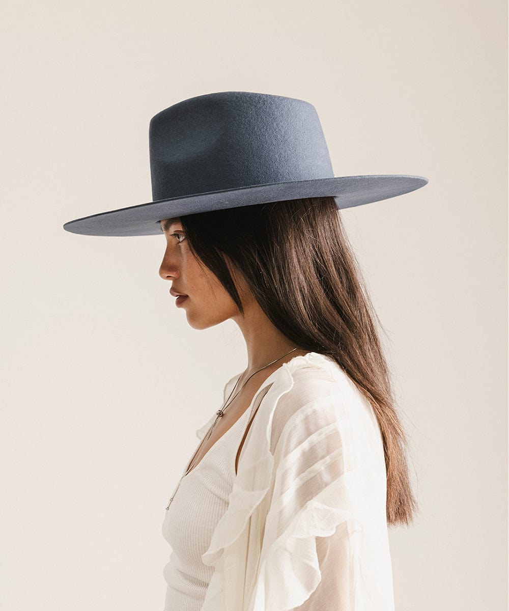 Woman wearing a navy blue wide-brimmed hat against a plain background
#color_vintage blue