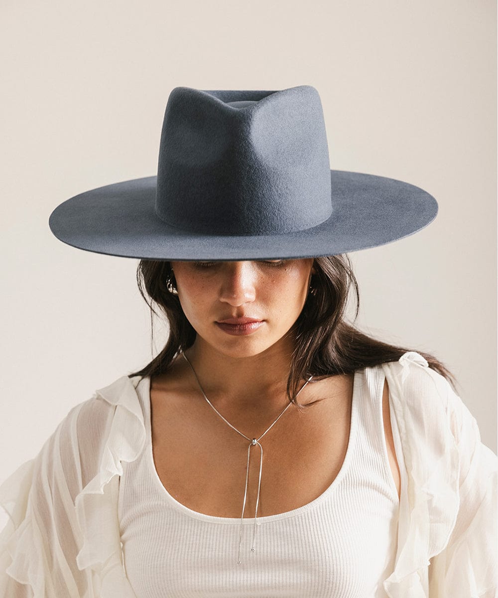 Woman wearing a blue hat against a plain background #color_vintage blue