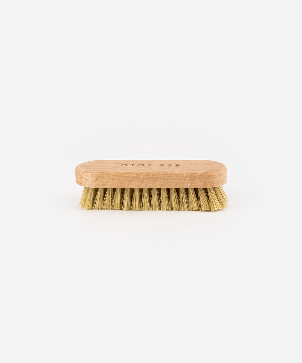 Hat brush with wooden handle on a white background