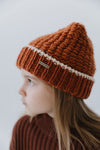 Gigi Pip beanies for kids - Kids Vail Beanie - 100% acrylic chunky knit beanie in a universal kids size featuring a comfortable plush inner band and the Gigi Pip logo on a metal bar in the front [burnt orange + cream]
