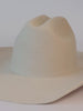 A video of a white cowboy hat being decorated with bands, lightning brand, and a star pin #color_off white