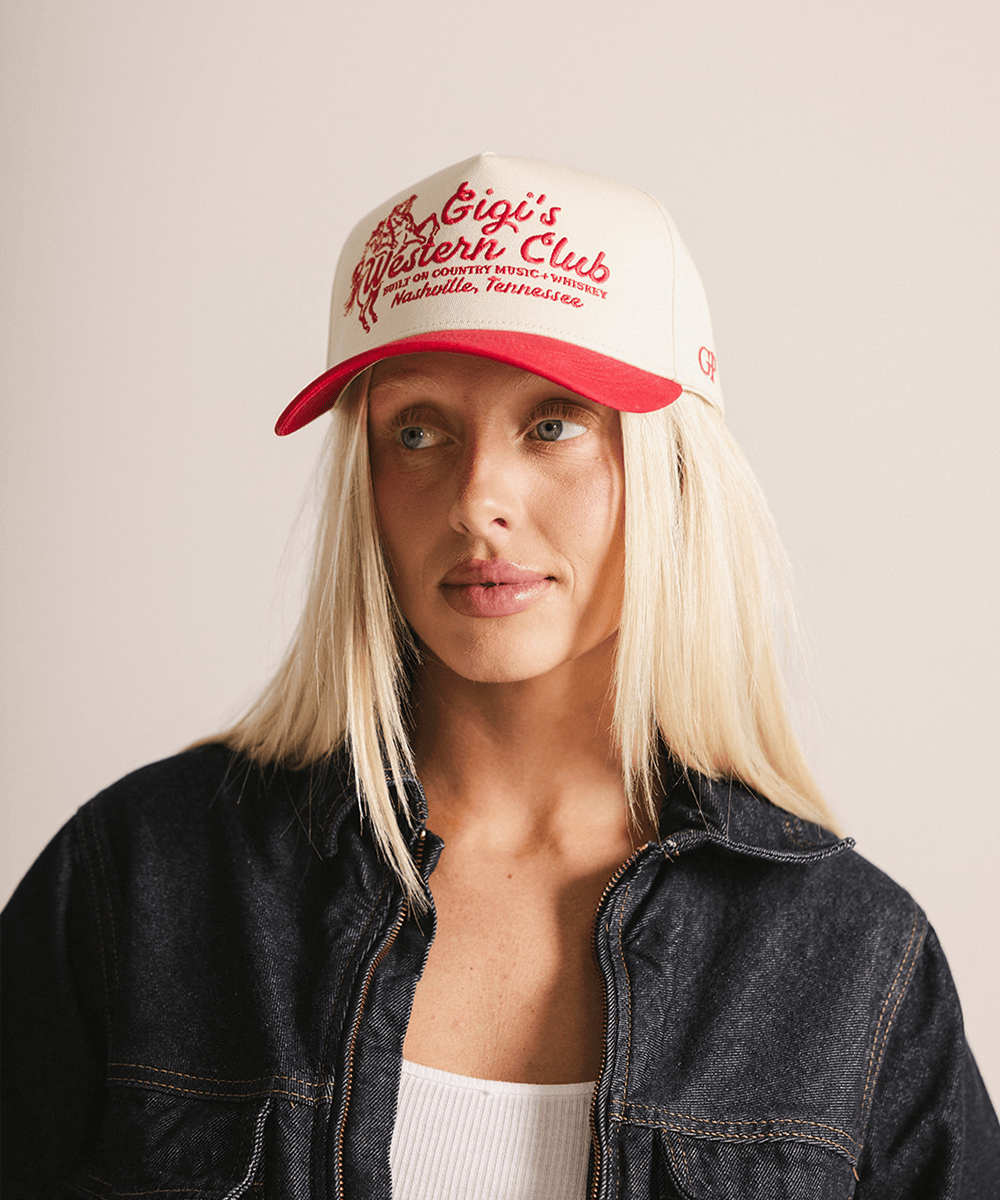 Person wearing a white cap with red text on a plain background #color_cream - red