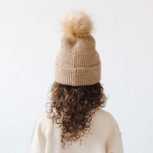 Gigi Pip beanies for kids - Milo Beanie - soft knit ribbers kid's beanie featuring a fold up brim with a rose gold Gigi Pip logo pin on the side of the fold and a pom pom on the center of the crown [camel]