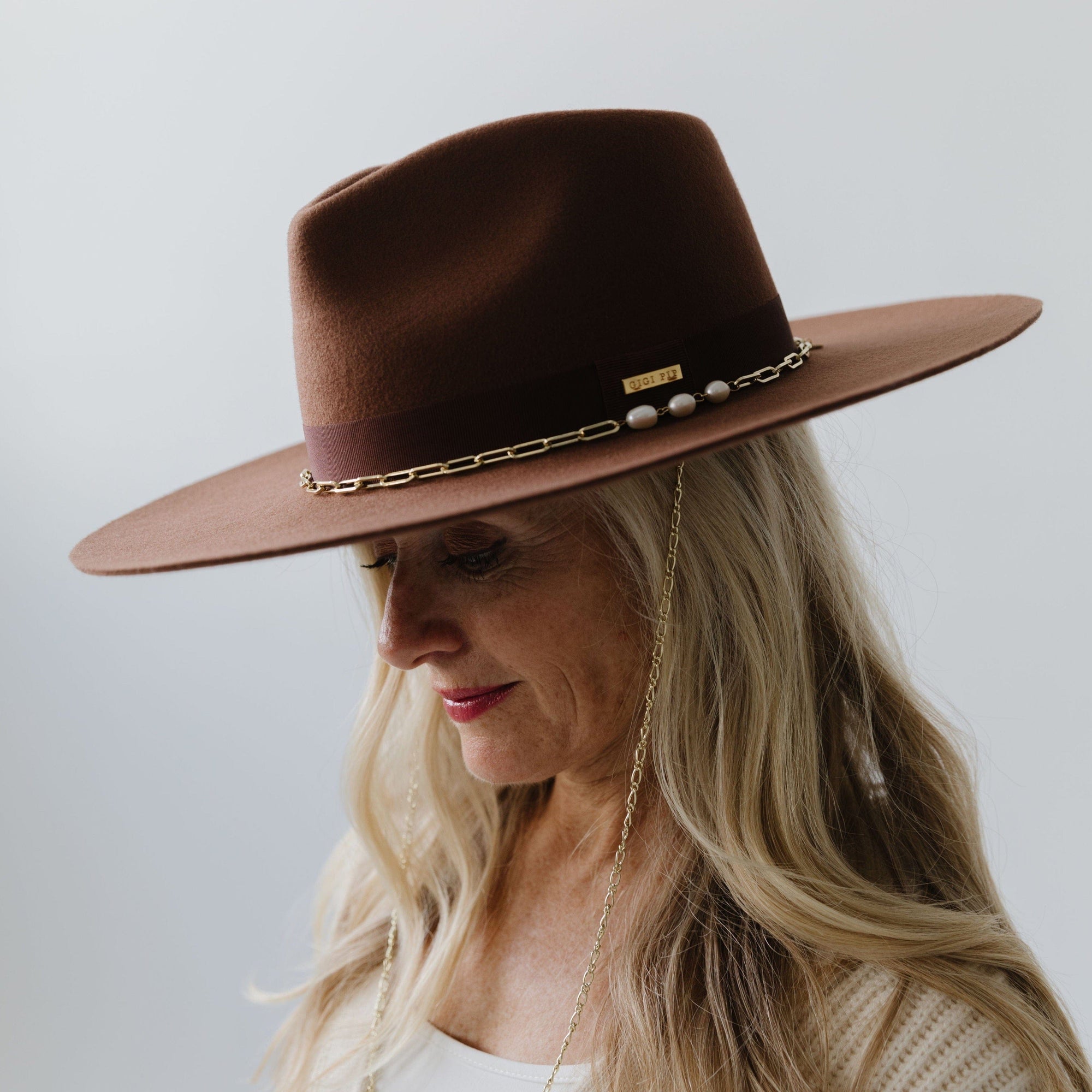 Gigi Pip felt hats for women - Raine Wide Brim Fedora - wide flat brim with a fedora crown, featuring a gold-plated removable paperclip brass chain with three faux pearls and a hand-sewn grosgrain band with the gold Gigi Pip bar around the crown, as well as a removable golden chain chinstrap [black]
