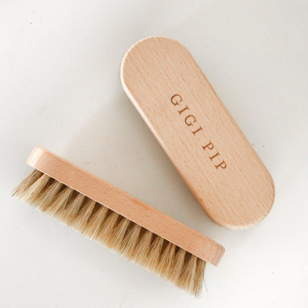 Gigi Pip hat care products - a handheld hat cleaning brush to remove dirt + lint made of wood + features the Gigi Pip name engraved on the handle [natural]