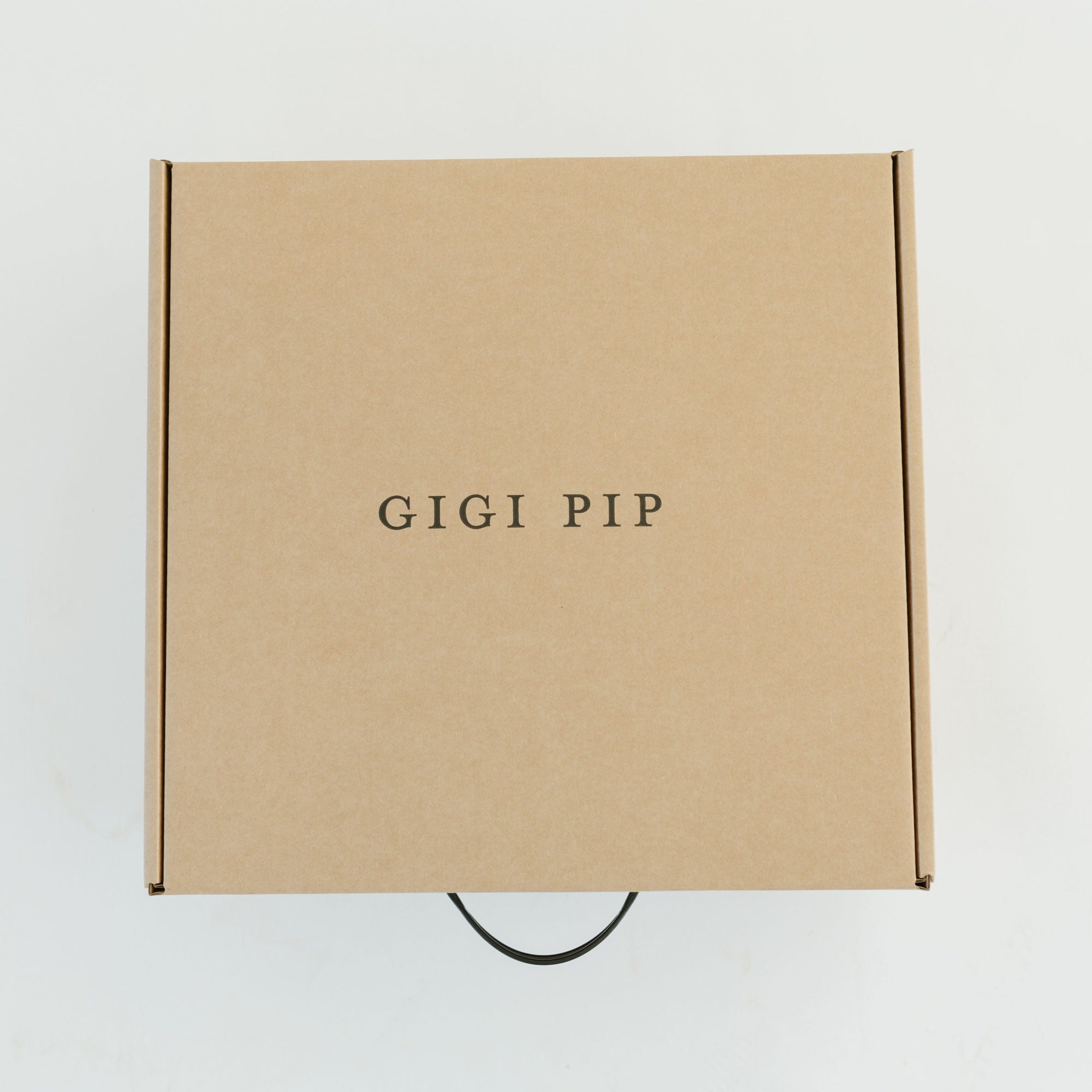 Gigi Pip hat care products - Hat Keepsake Box - foldover cardboard box with plastic handle, able to hold up to three hats for storage + comes with a Gigi Pip branded hat keepsake bag [natural]